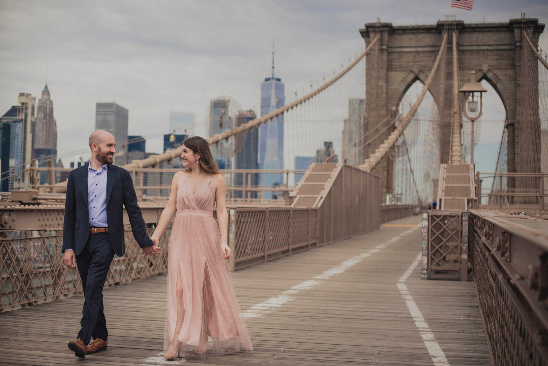 Lauren Levy walking on bridge holding mans hand