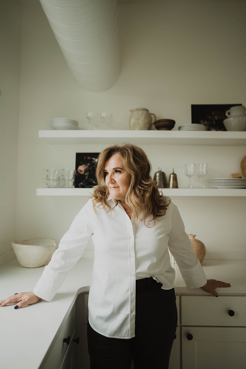 Nanette Johnson standing in her kitchen.