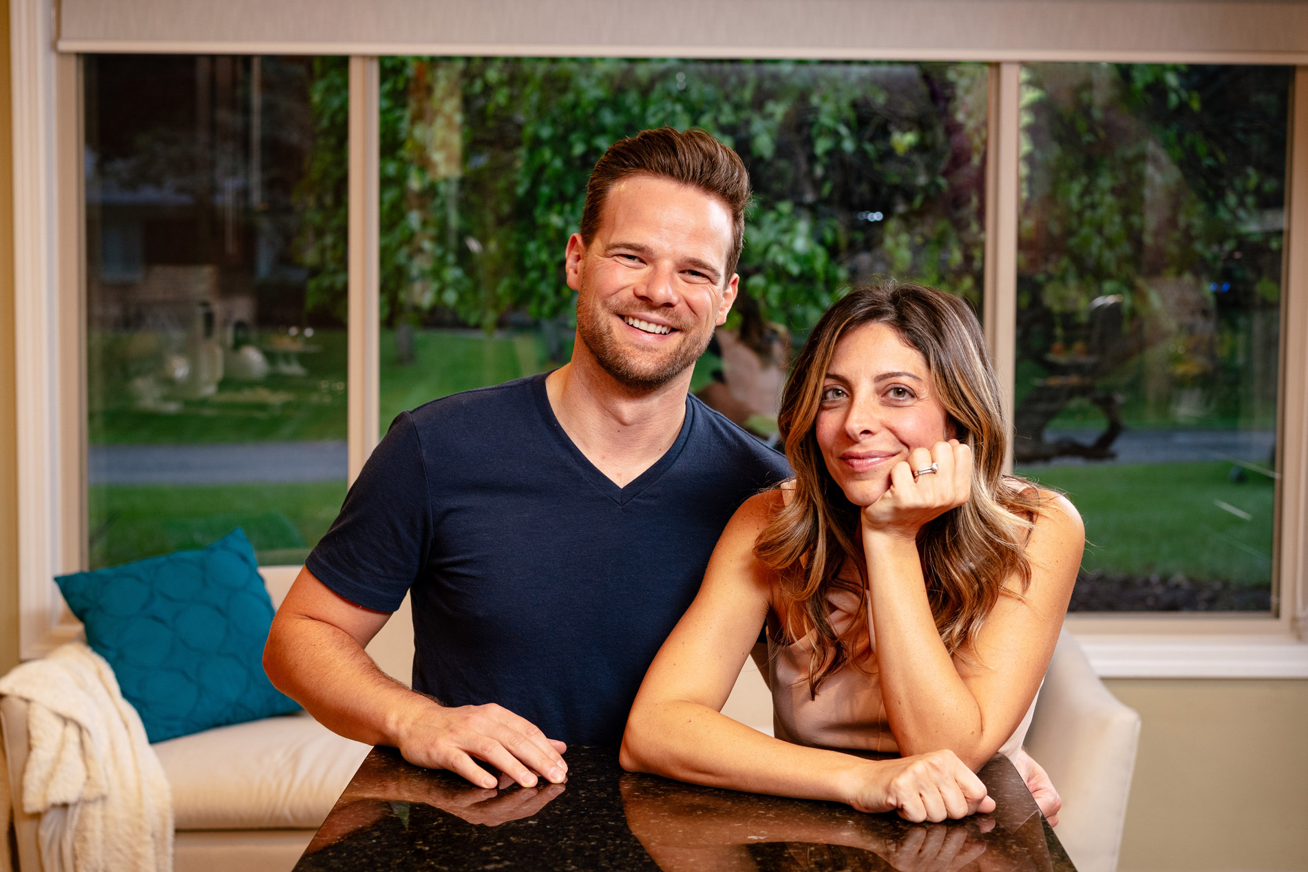 Andy Hill with his wife sitting on sofa