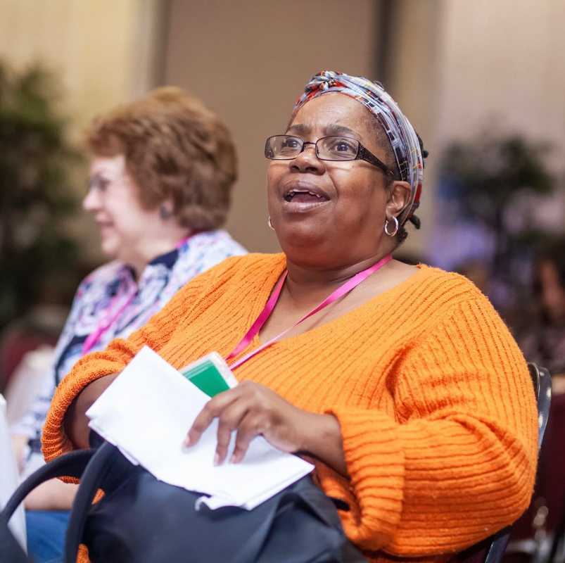 Woman laughing during Dr. Smith's seminar.